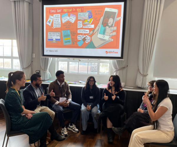 Kelechi Alozie discussing healthcare at AI Youth Council in a group